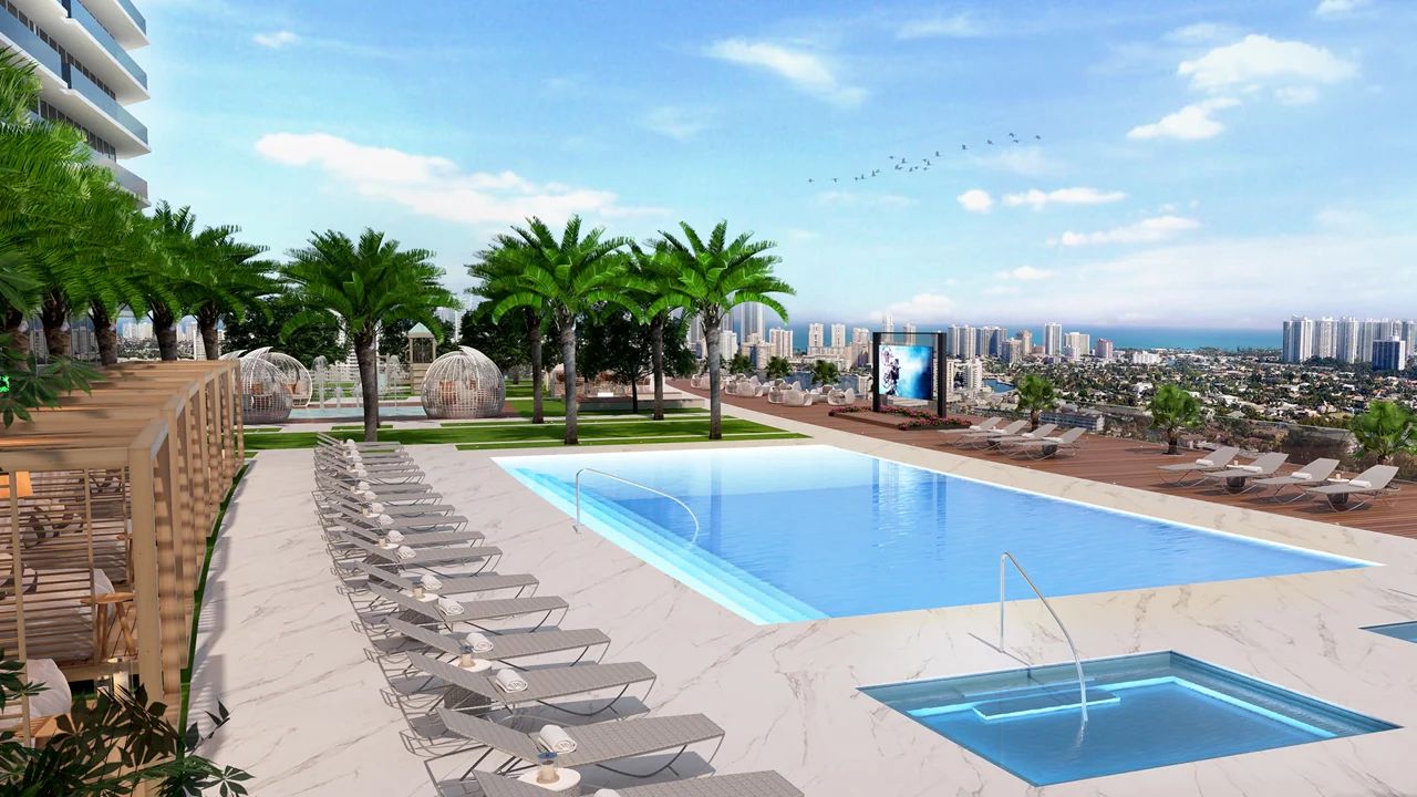 Resort-Style Pool with Cabanas Overlooking Hallandale Beach Skyline at Oasis Hallandale, Featuring Lush Greenery and Expansive Sun Deck