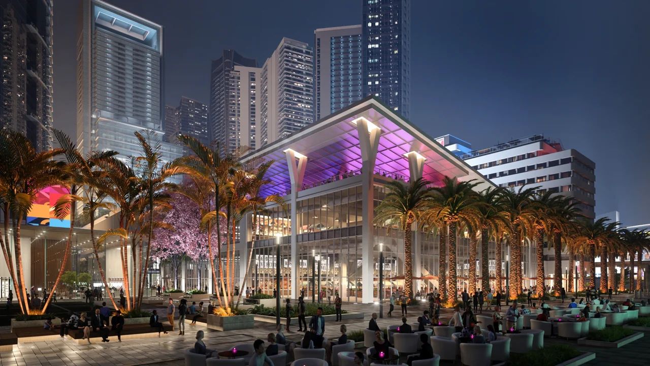 Evening View of a Bustling Park West Street With Palm Trees and the Miami World Center Promenade Illuminated