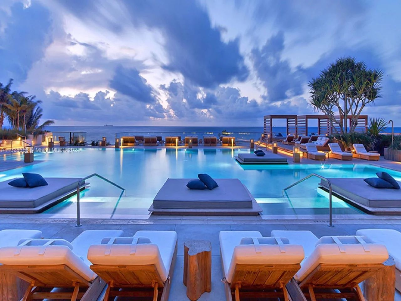 1 Hotel and Homes with pool and lounge chairs
