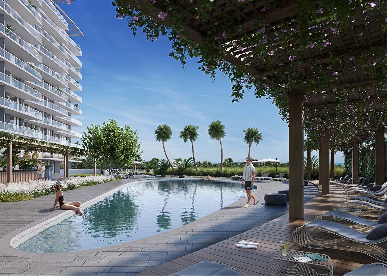 Piscina de Lujo Estilo Resort con Estantes para Tomar el Sol y Sillas Lounge Cubiertas en Nexo Residences