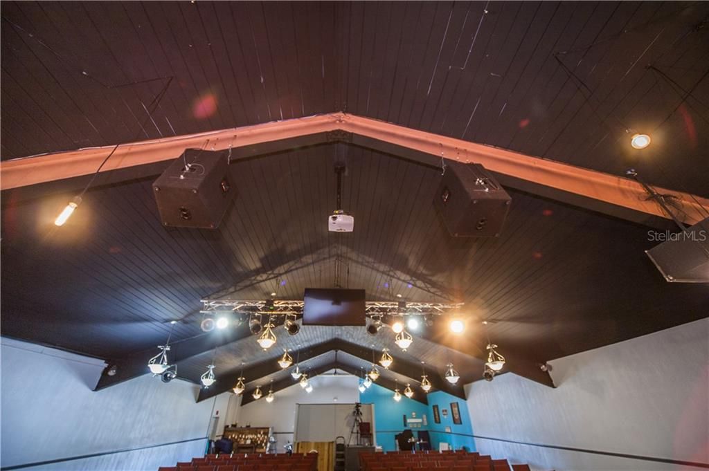 The sound system, projection system, and stage lighting do not convey with the real property but are subject to negotiation. The hanging chandeliers do convey.