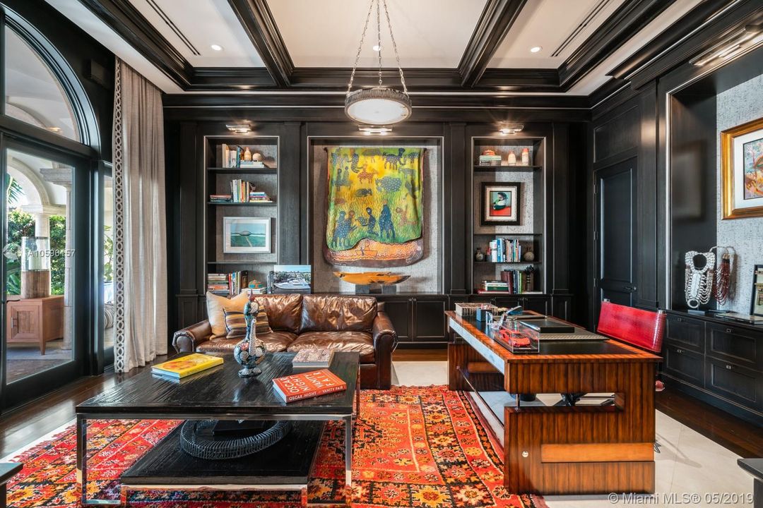 Library/Den with wood paneling off the living room