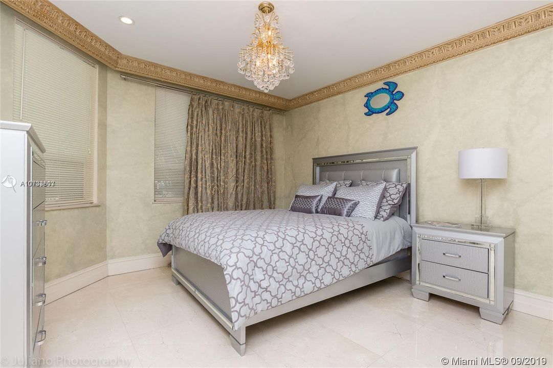Guest bedroom downstairs with stylish furniture, queen bed