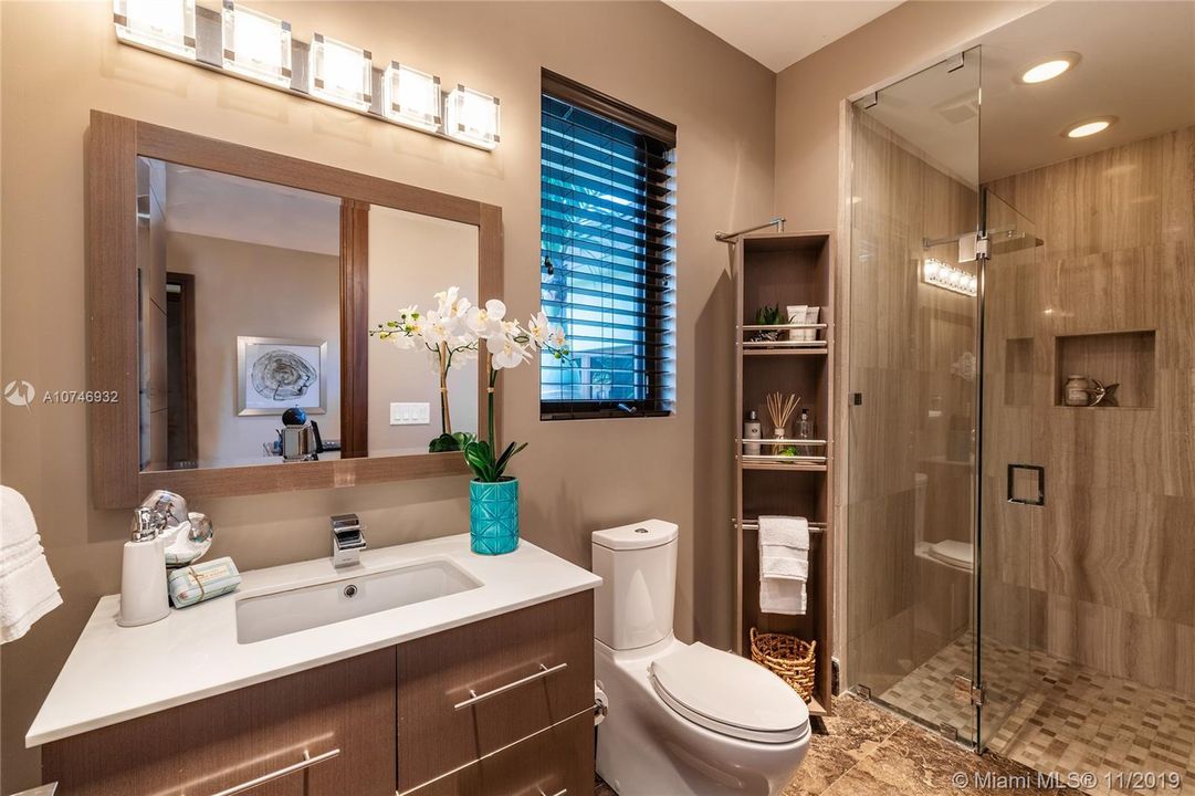 Bathroom 5, another unique bathroom with beautiful finishes, custom cabinetry, glass enclosure, etc