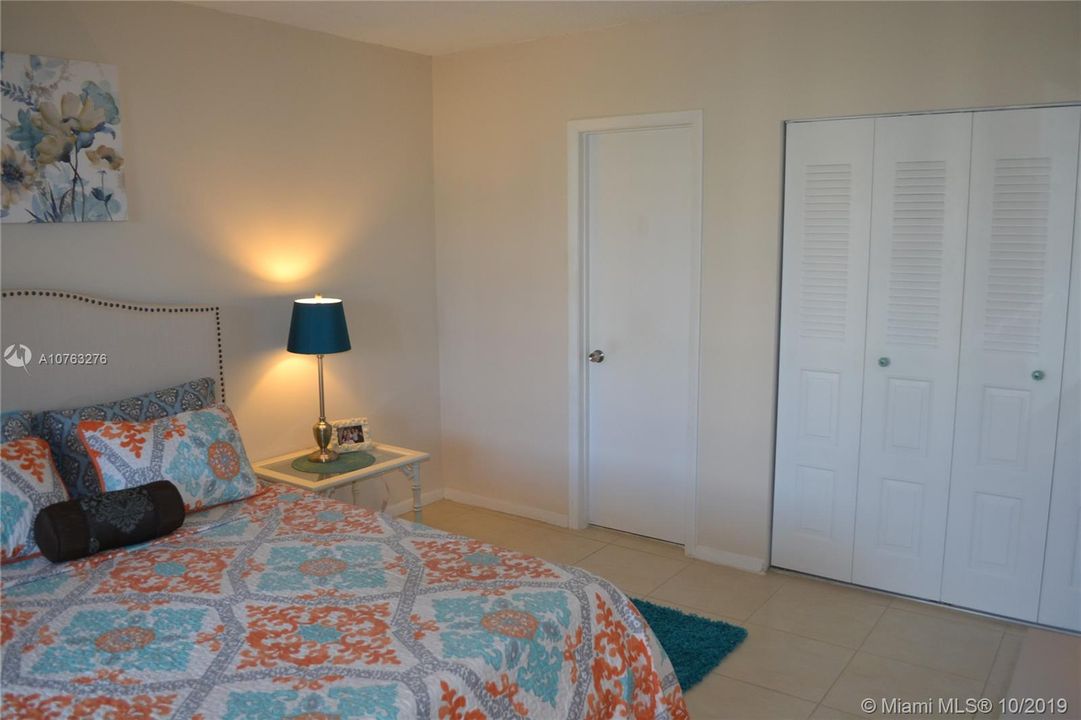 Bedroom with entrance to half bath and walk in closet area