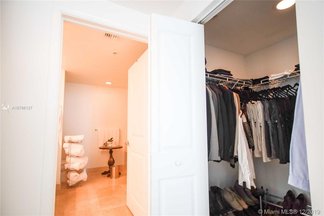 Master Bedroom hallway with Walk-In Closet & Large Master Bathroom with Marble Floor.