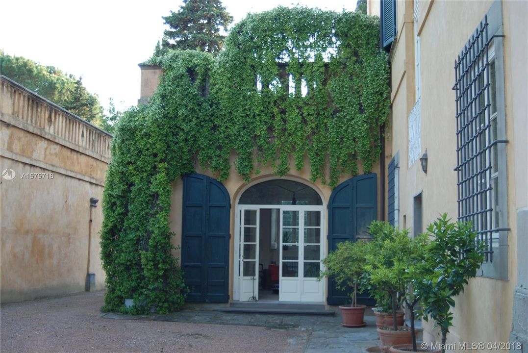 Side entry to the 'sun room' with cascading greenery and shuttered doorways