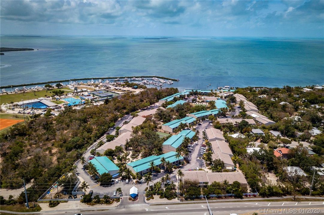 Aerial View of Community, gated complete with docks, pool, picnic areas, clubhouse, and tennis court.