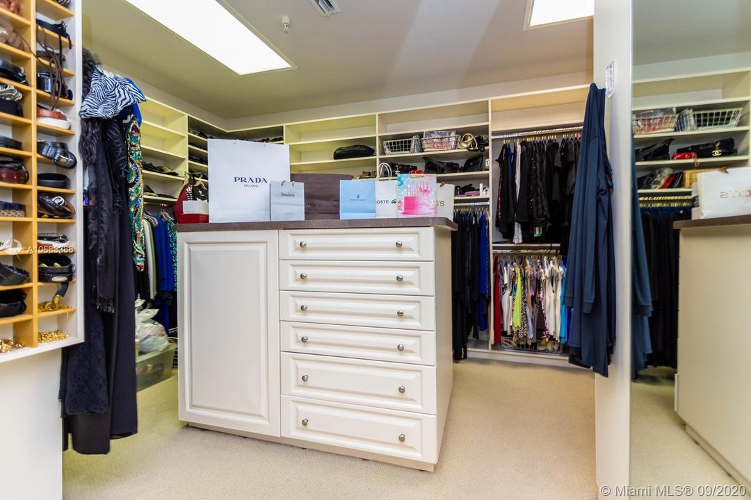 One of two walk-in closets. Plenty of space for shoes, bags, belts, clothes and more