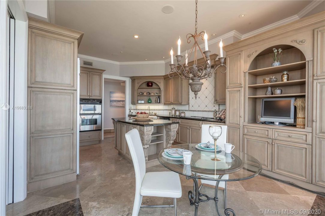 Granite counters, island, stainless steel appliances and lots of storage space