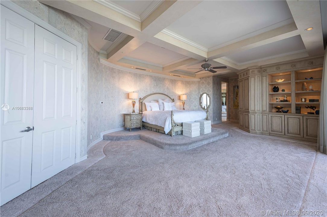 Decorative ceiling and soft wallpaper in the master suite