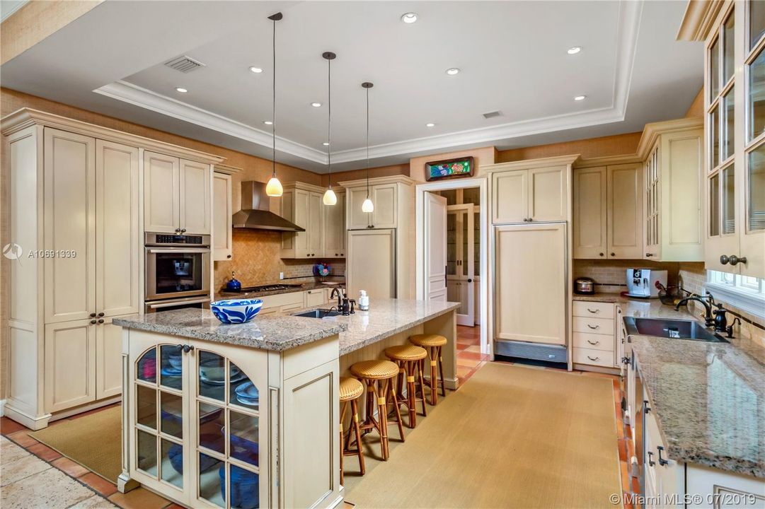 OPEN KITCHEN WITH GAS COOK TOP, WOOD CABINETS AND GRANITE COUNTERS