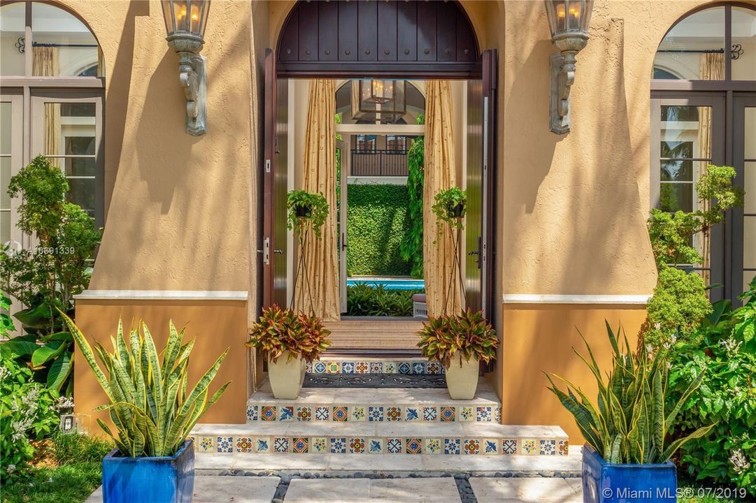 FRONT DOOR OPENS TO POOL VIEW