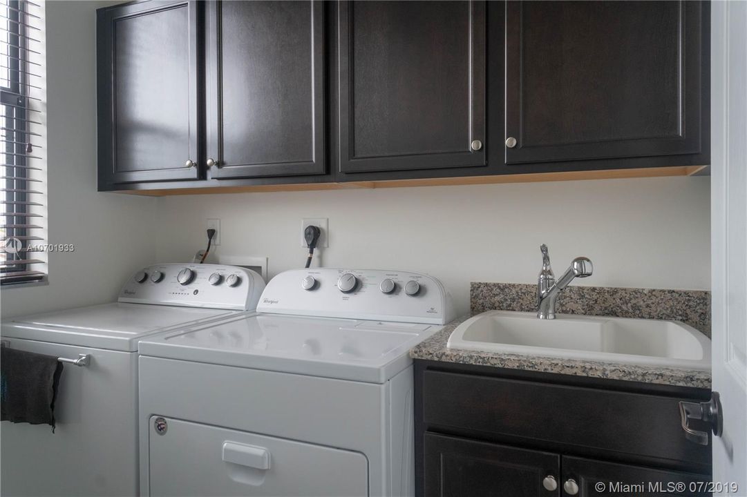 full sized washer dryer, full cabinets, sink