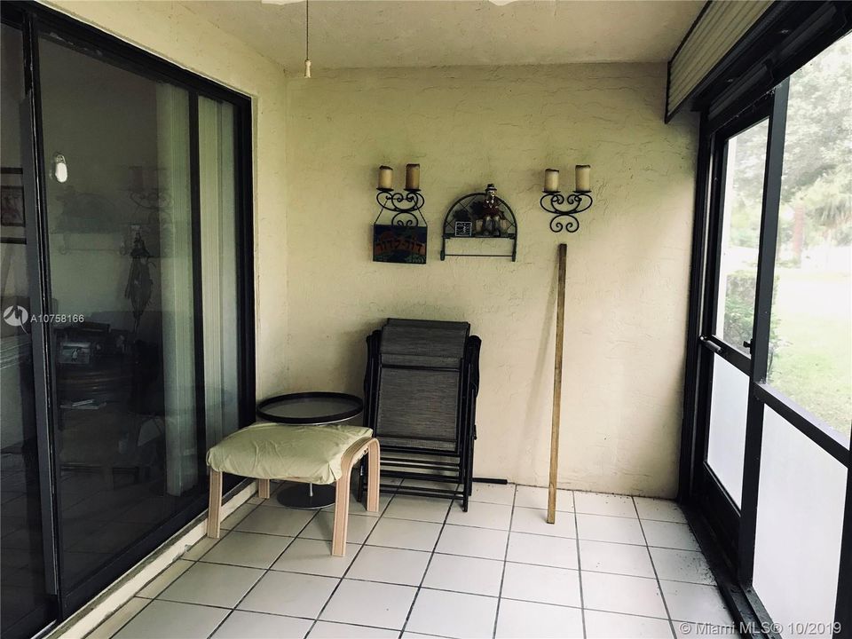 TILED SCREENED PORCH OPENS TO THE LIVING ROOM AND MASTER BEDROOM