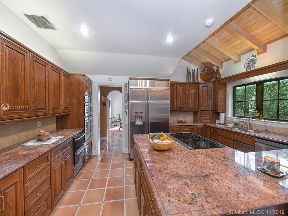 803 N. Greenway Dr., Coral Gables - Chef's eat-in kitchen with all the "tools of the trade", includes Jenn-Air fridge, 2 warming drawers.