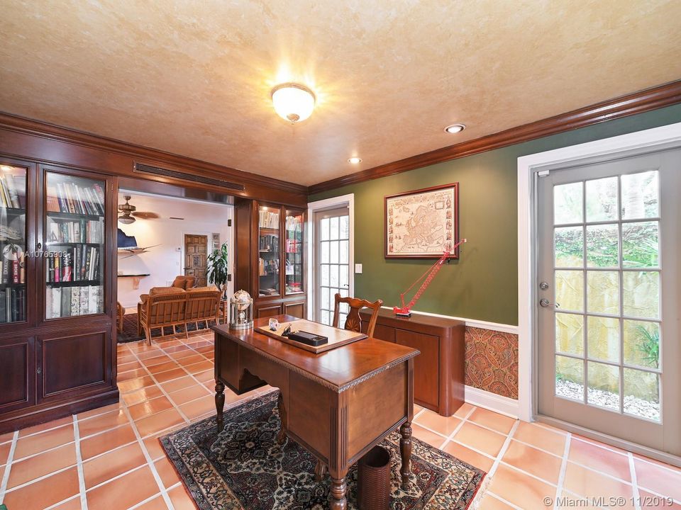 803 N. Greenway Dr., Coral Gables - Library/office with built-ins and en-suite half bathroom. It can also be accessed from outside.