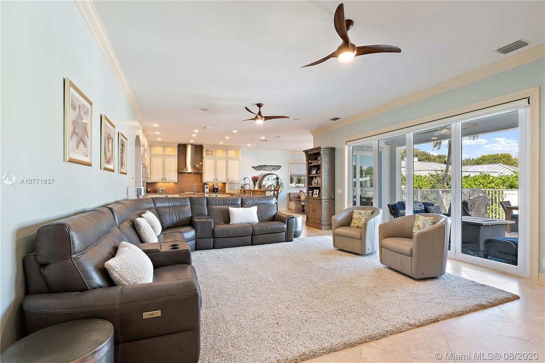 Family room and kitchen. Family has an interior remote control screen to allow a breeze to come through the family room.