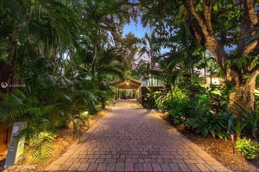 Dramatic tree lined entrance to 2410 Oakbrook.  Brick pavers, mature oak trees filled with peacocks.. A typical Coconut Grove lifestyle.