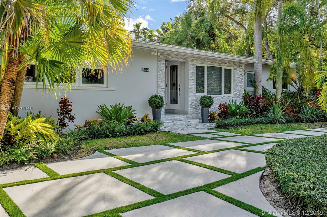 Exterior front with modern concrete square driveway