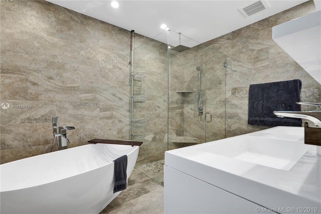 Master Bathroom with soaking tub, frame-less glass shower and dual sinks.