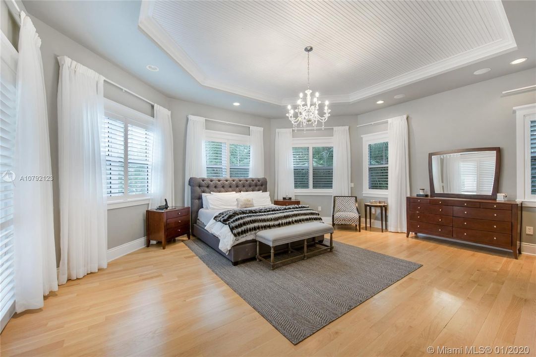 Over-sized Master Bedroom with Bay Windows facing backyard, pool and waterway.