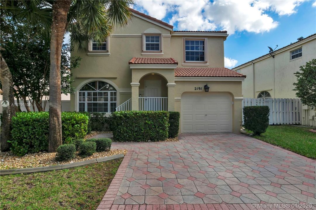 Great starter home in the gated community of Cedar Way at Towngate in Pembroke Pines with brick pavered driveway, accordion shutters upstairs and a fully fenced well maintained yard