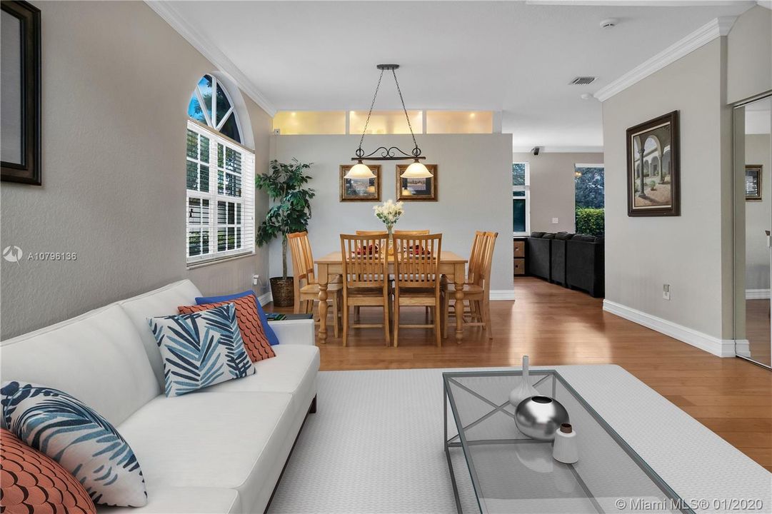 Gorgeous light wood flooring throughout living area add elegance and warmth