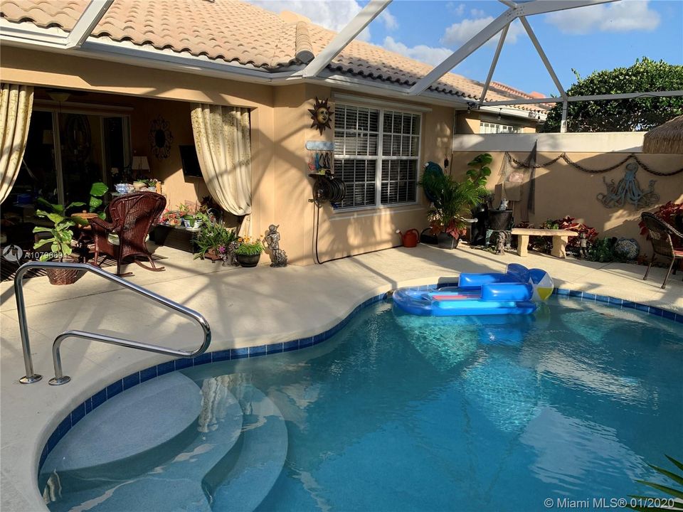 Sit back and enjoy the privacy of this screened enclosed pool and patio.