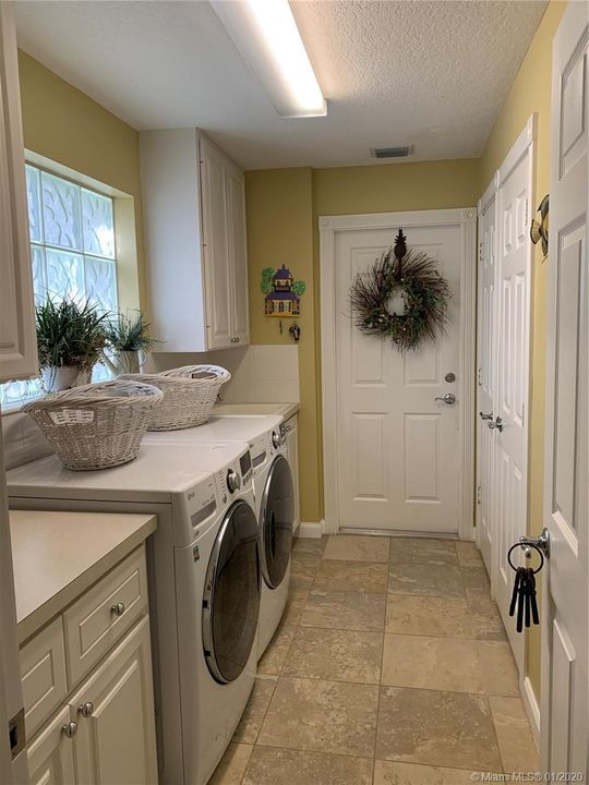 Spacious Laundry Room with plenty of storage and closet