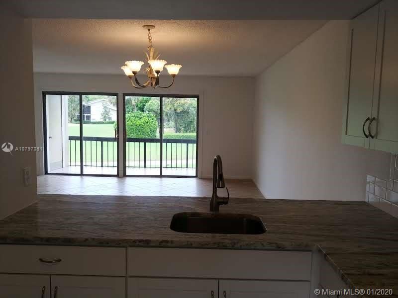 Views from kitchen to living area and golf course