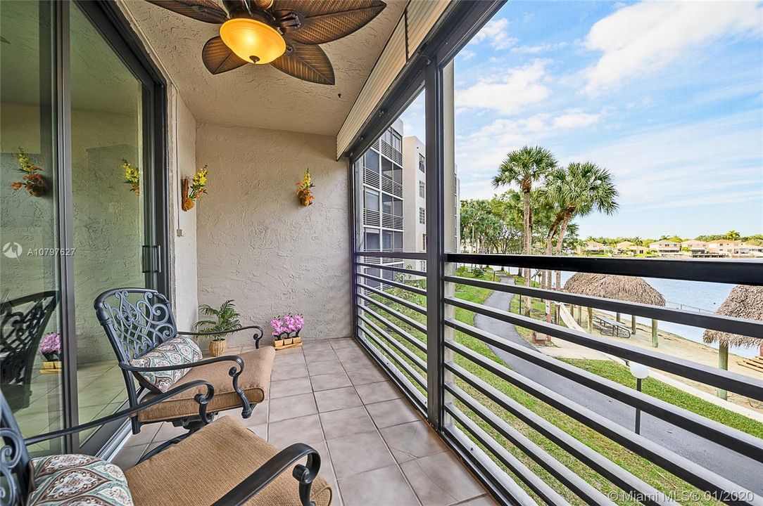 Screened patio overlooking community beach area and lake.  Notice the walking path for exercising in scenic surroundings.