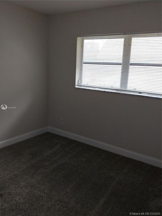 2nd Bedroom with new paint, carpet, and large walk in closet.