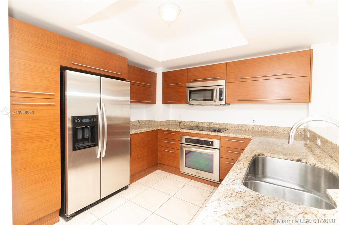Spacious, upgraded kitchen with contemporary finishes, ample storage and counter space