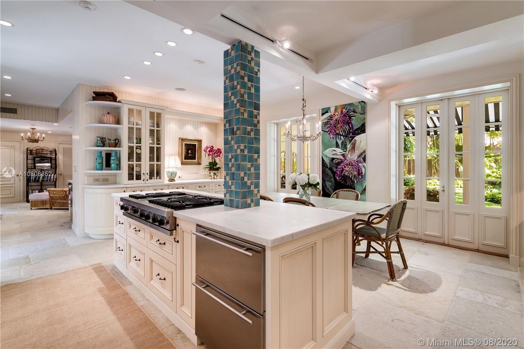 Professional gas cooktop and refrigerator drawers complete the island