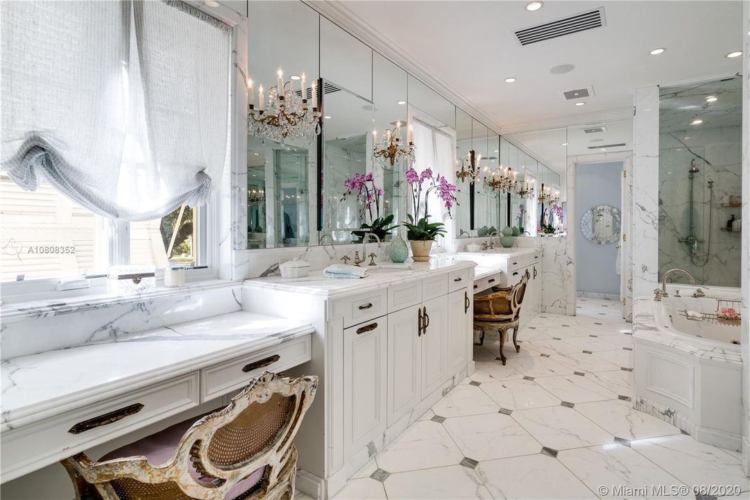 Double vanities and sinks with elegant white marble throughout