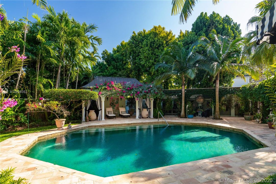 Orchids, bougainvillea and palm trees surround the yard