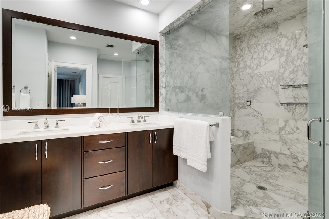 Master bathroom features walk-in shower with built-in seat