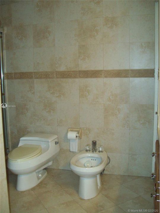 Master bath has bidet and is completely tiled