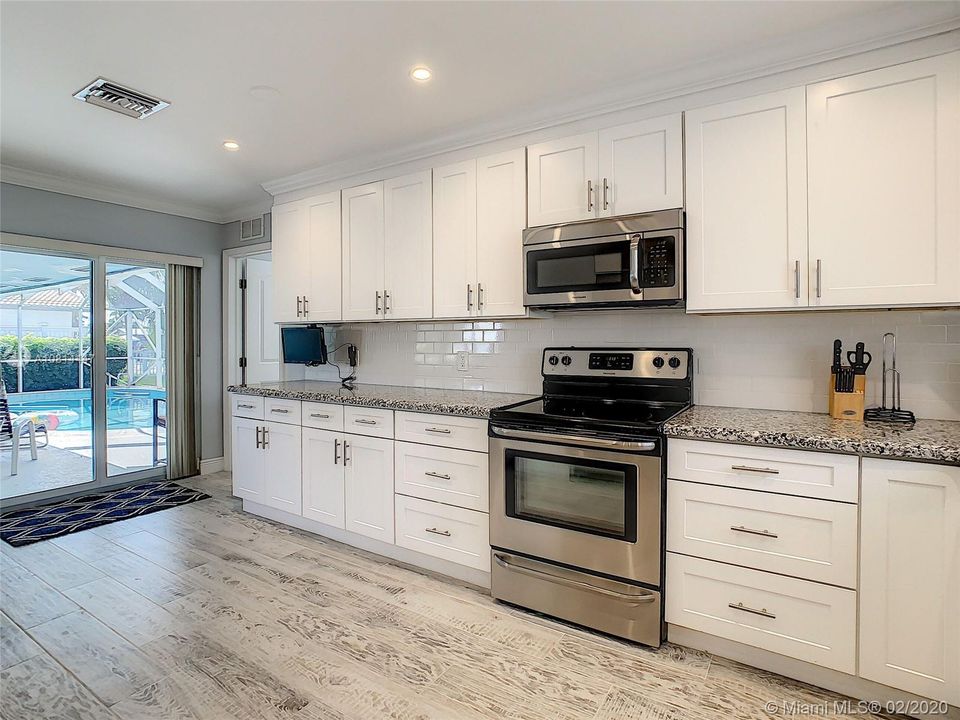 Another view of the Kitchen with New Appliances and High Hat lighting.