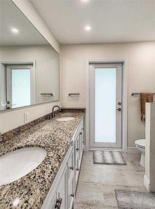 Guest Bathroom has been updated with Granite counters, seamless shower door, high hat lighting and more.