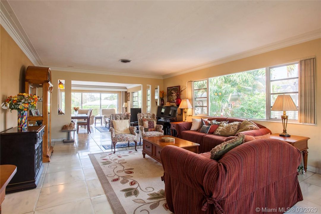 JUST PAST THE FOYER ENTRANCE OF THE HOME . LOOKING AT HUGE ADJOINING LIVING & DINING ROOMS