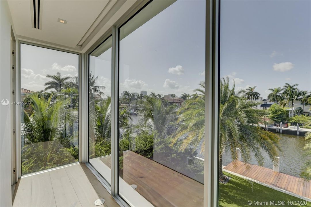 Bedroom #4 views to downtown skyline at night, twinkling lights. Hall to ensuite bathroom