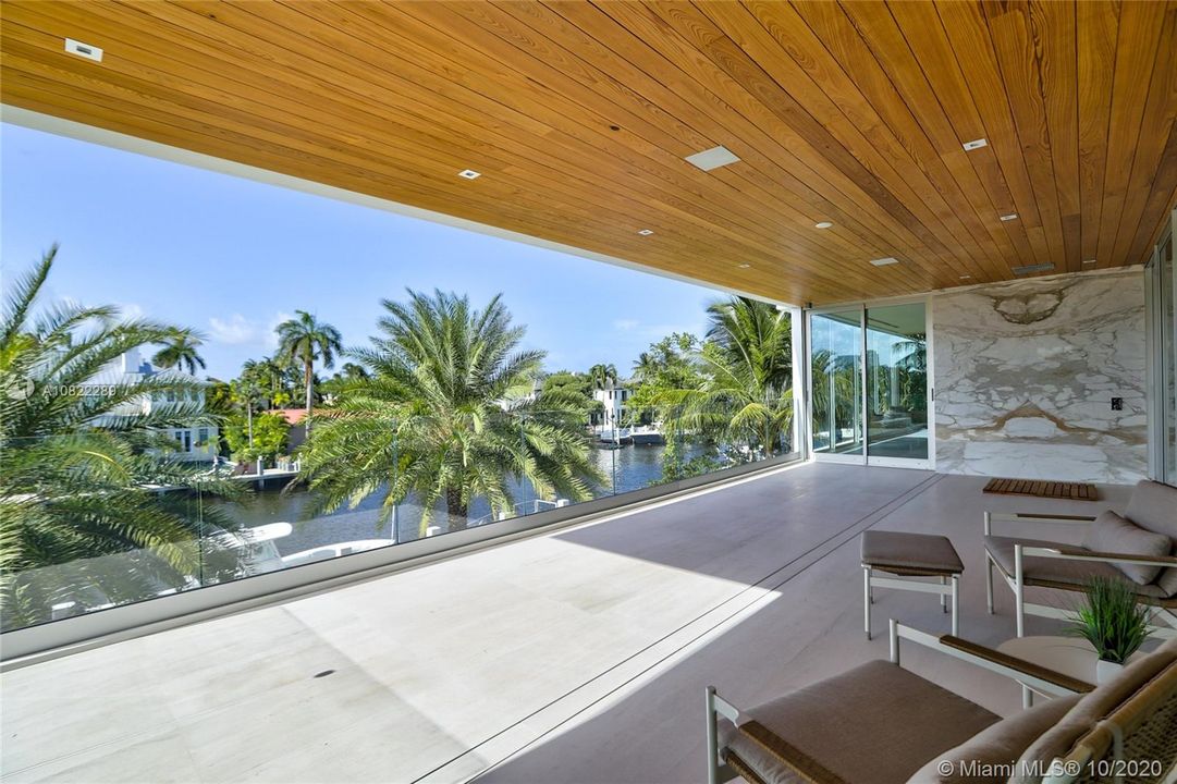Linear Drain for limestone balcony flooring, Calacatta Gold slabs over the outdoor shower are a gorgeous accent wall