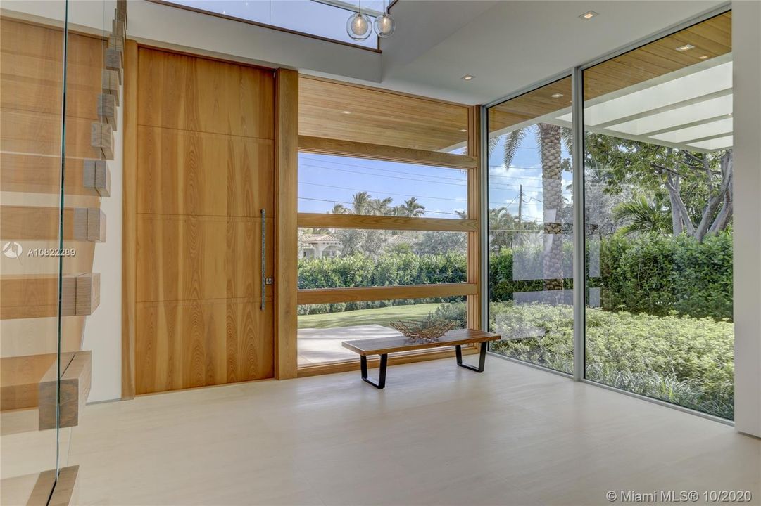 Front door & windows made of cypress wood. Lots of privacy & green space with a tall clusia hedge. True floating stairs & seamless glass railings