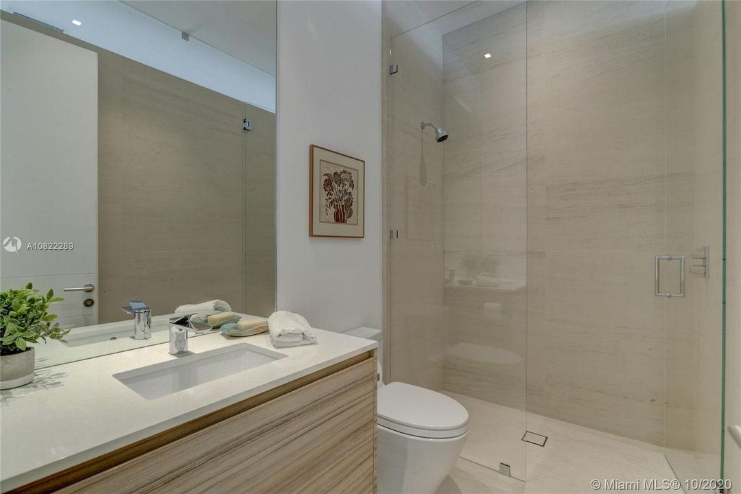Downstairs full bath for bedroom. Limestone walls & flooring. Dornbracht fixtures