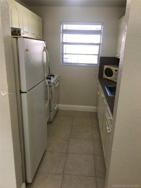 KITCHEN WITH REFRIGERATOR, GAS STOVE AND MICROWAVE