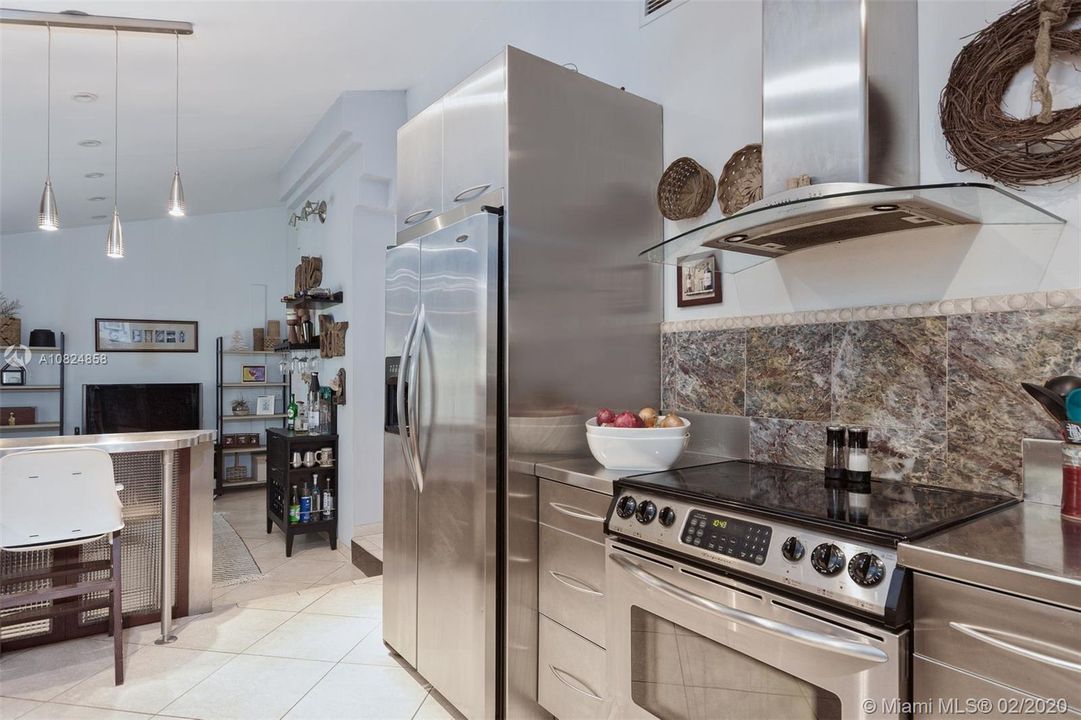 High volume ceilings and open kitchen/bar area connects the heart of the home.