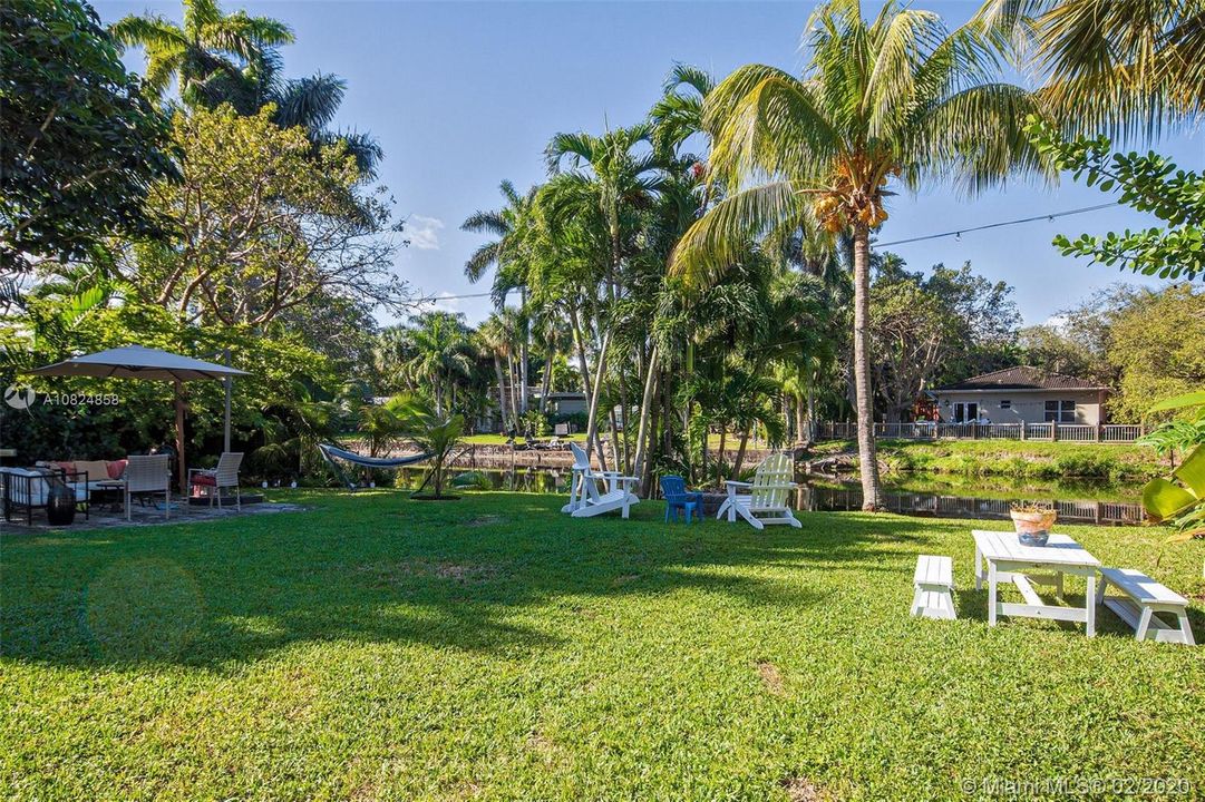 Canal front private yard with room for pool.