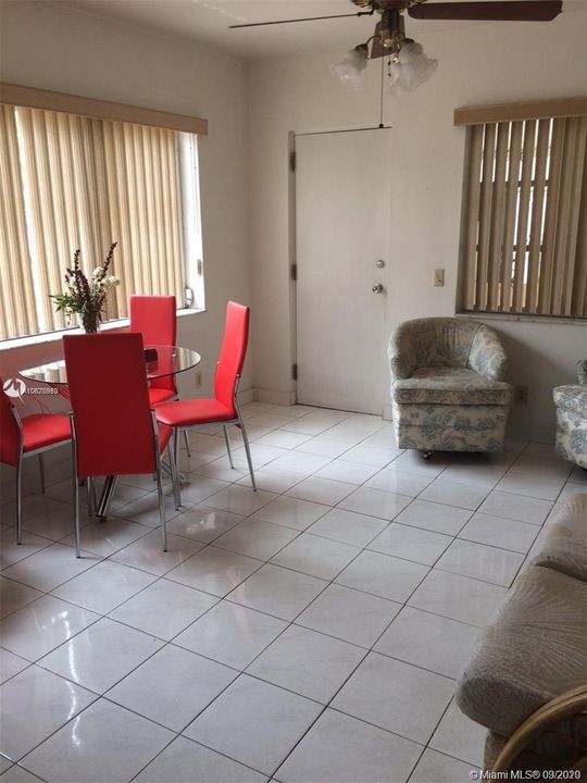 Family room with door leading to back covered porch with laundry